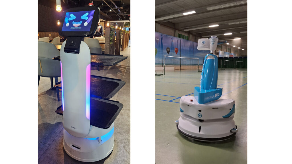 Kaksi erilaista robottia,tarjoilijarobotti ja siivousrobotti.